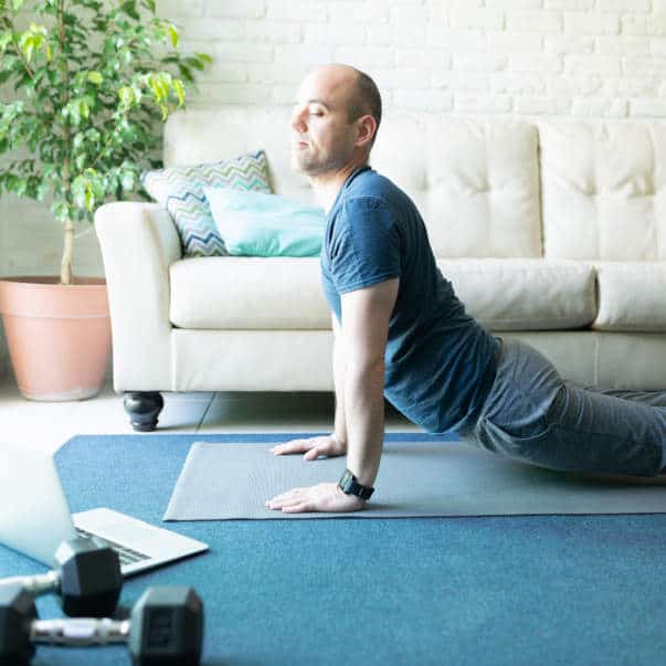 yoga-for-lower-back-sq man enjoying cobra pose on our live yoga classes online
