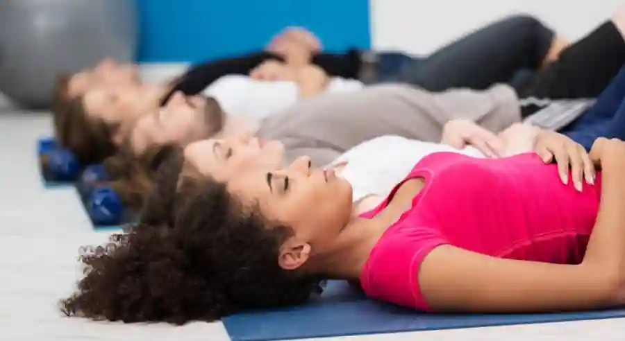 group practicing mind body relaxation through yoga nidra