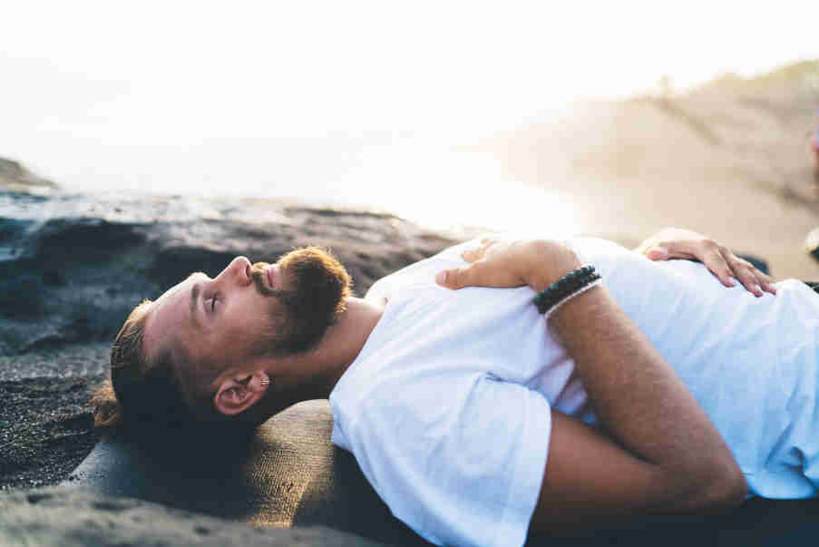 young man practising breathing exercise for dysfunctional breathing