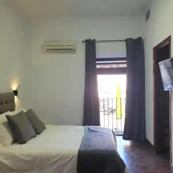room with bed and balcony in hostal cuzco, the budget recommendation for our spanish yoga retreats