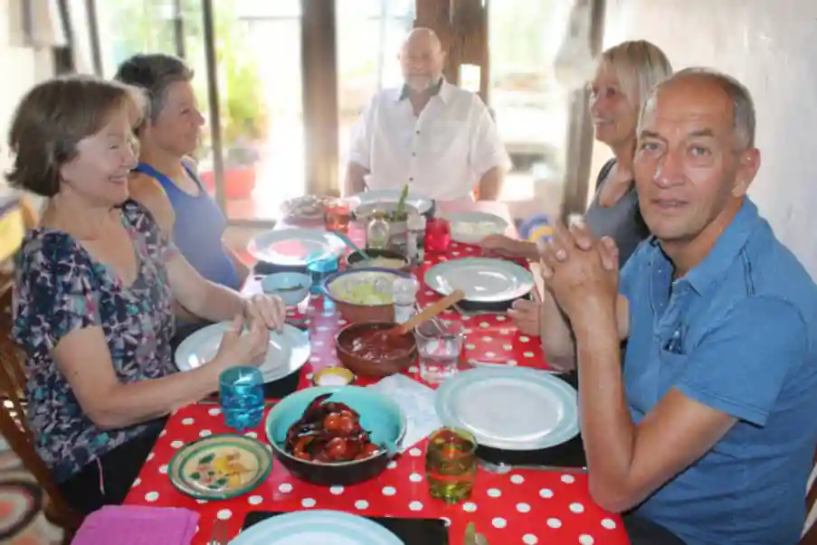 group of happy people eating a full veggie lunch on one of our yoga retreats