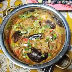 aubergine do pyaza served with in a traditionl indian copper pot