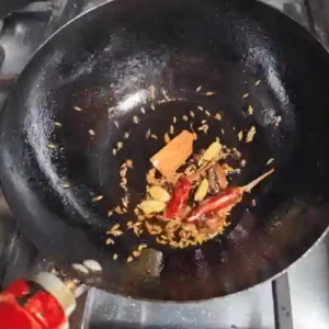 whole spices being tempered in hot oil as a starter / tarka for many Indian dishes