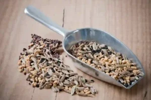 whole bengali five spice panch phoron on a wodden counter, with scoop
