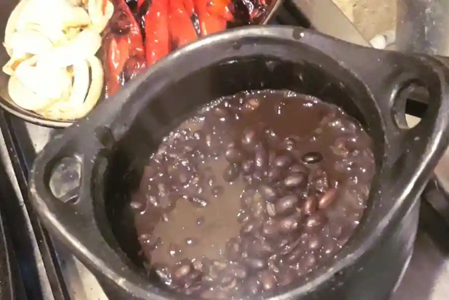 Mexican black beans in a black clay pot