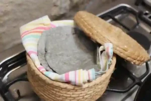 blue corn tortillas kept warm in a basket - chiquihuite, with colourful tea-towel