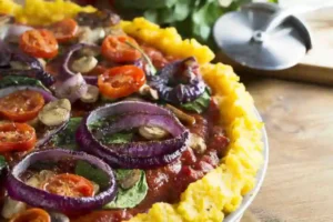 nixtamalized corn pizza-tamal with tomato sauce and vegetable toppings
