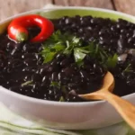 recipe for Mexican black beans served in an earthenware dish