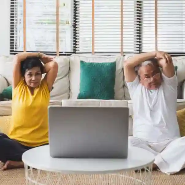 online-yoga-class-sq older couple practicing yoga online for back and neck health