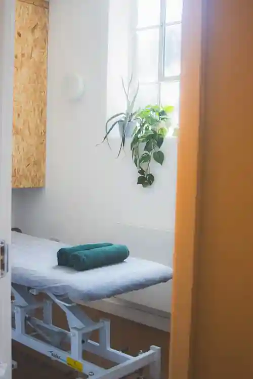treatment room with couch and towels at East Of Eden yoga, pilates and osteopathy clinic in London Walthamstow