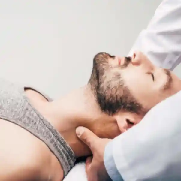 young man benefiting from a neck adjustment from a structural osteopath