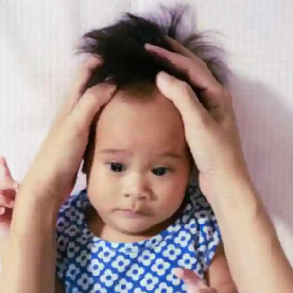 Calm baby receiving cranial osteopathic treatment 