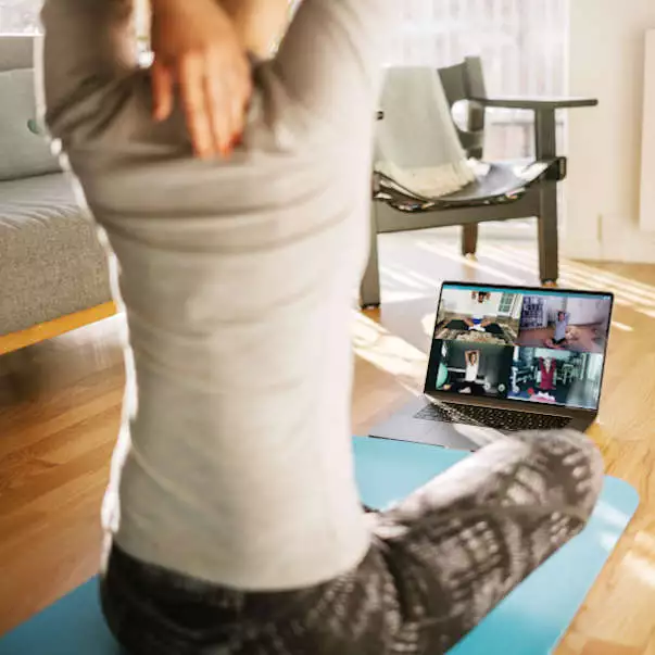 wellbeing-yoga-live-online woman practicing yoga on a live zoom group class